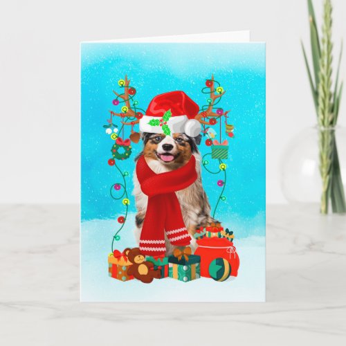 Australian shepherd in snow with Christmas gifts  Card