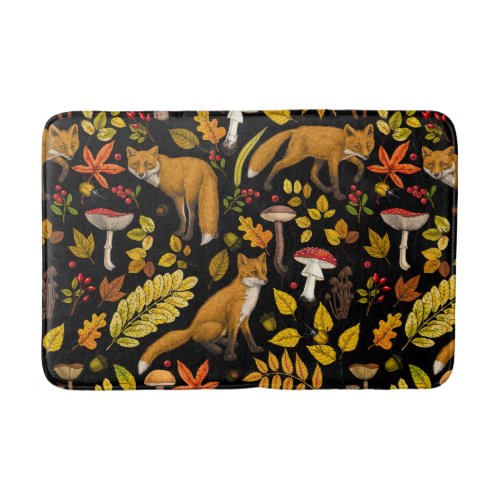 Autumn foxes on black bath mat
