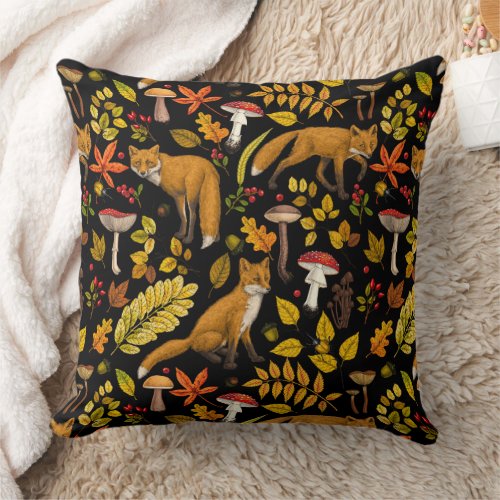 Autumn foxes on black throw pillow