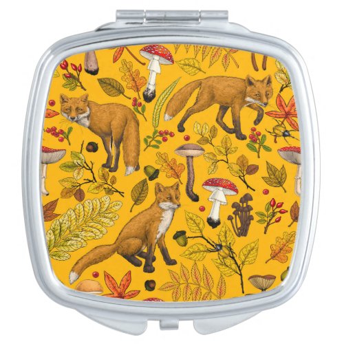 Autumn foxes on orange compact mirror