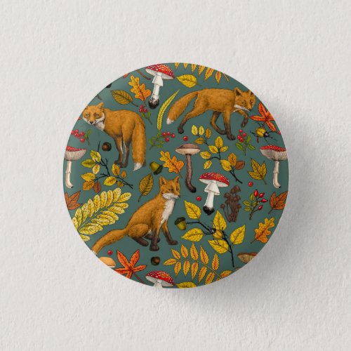 Autumn foxes on pine green button