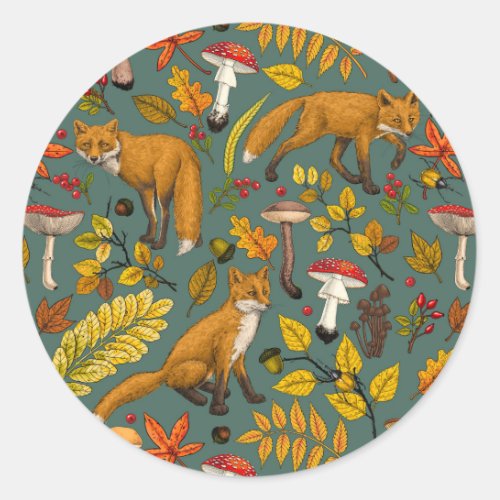 Autumn foxes on pine green classic round sticker