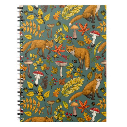 Autumn foxes on pine green notebook