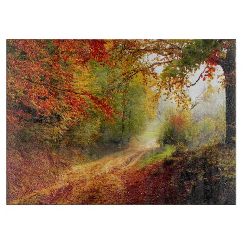 Autumn Leaves and Trees Covering Dirt Road Cutting Board