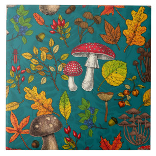 Autumn mushrooms, leaves, nuts and berries on blue ceramic tile
