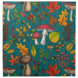 Autumn mushrooms, leaves, nuts and berries on blue cloth napkin