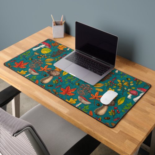 Autumn mushrooms leaves nuts and berries on blue desk mat