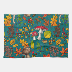 Autumn mushrooms, leaves, nuts and berries on blue kitchen towel