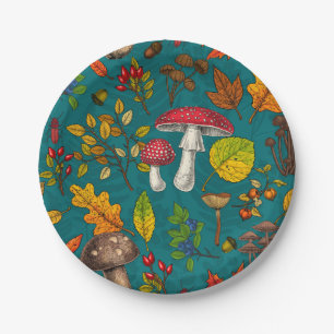 Autumn mushrooms, leaves, nuts and berries on blue paper plates