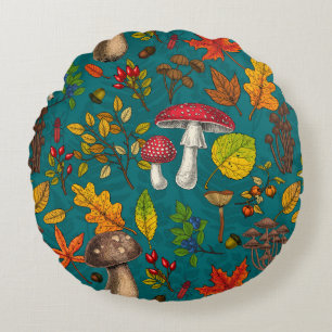 Autumn mushrooms, leaves, nuts and berries on blue round pillow