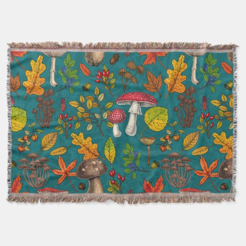 Autumn mushrooms leaves nuts and berries on blue throw blanket