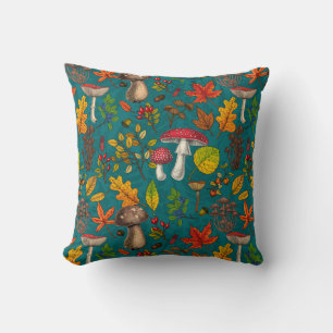 Autumn mushrooms, leaves, nuts and berries on blue throw pillow