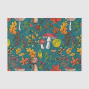 Autumn mushrooms, leaves, nuts and berries on blue tissue paper