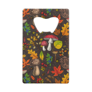 Autumn mushrooms, leaves, nuts and berries on dark credit card bottle opener