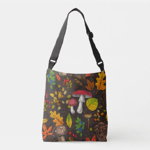 Autumn mushrooms, leaves, nuts and berries on dark crossbody bag