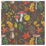 Autumn mushrooms, leaves, nuts and berries on dark fabric