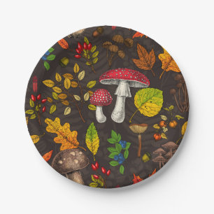 Autumn mushrooms, leaves, nuts and berries on dark paper plates