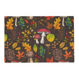 Autumn mushrooms, leaves, nuts and berries on dark placemat