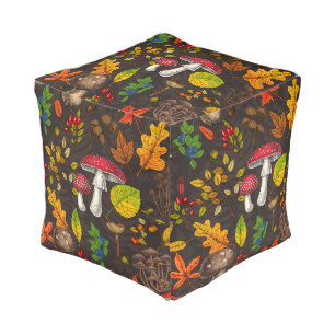 Autumn mushrooms, leaves, nuts and berries on dark pouf