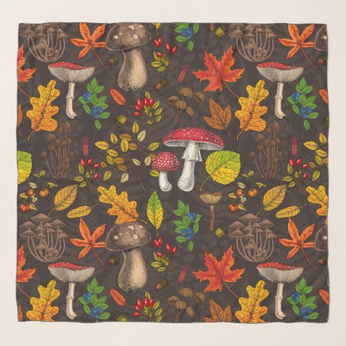 Autumn mushrooms leaves nuts and berries on dark scarf