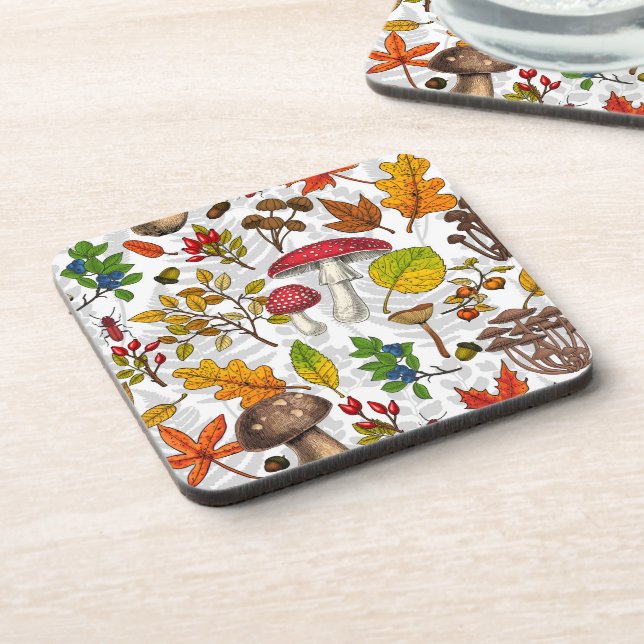 Autumn mushrooms, leaves, nuts and berries on whit beverage coaster (Left Side)