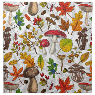 Autumn mushrooms, leaves, nuts and berries on whit cloth napkin