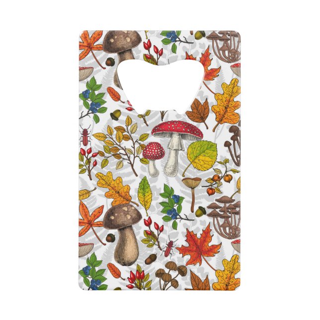 Autumn mushrooms, leaves, nuts and berries on whit credit card bottle opener (Front)