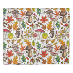 Autumn mushrooms, leaves, nuts and berries on whit duvet cover