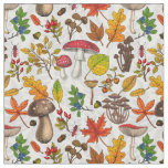 Autumn mushrooms, leaves, nuts and berries on whit fabric