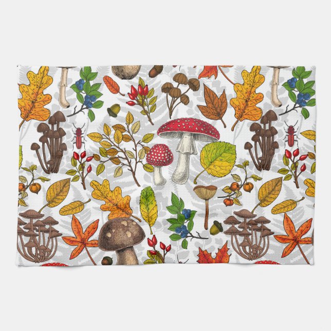Autumn mushrooms, leaves, nuts and berries on whit kitchen towel (Horizontal)