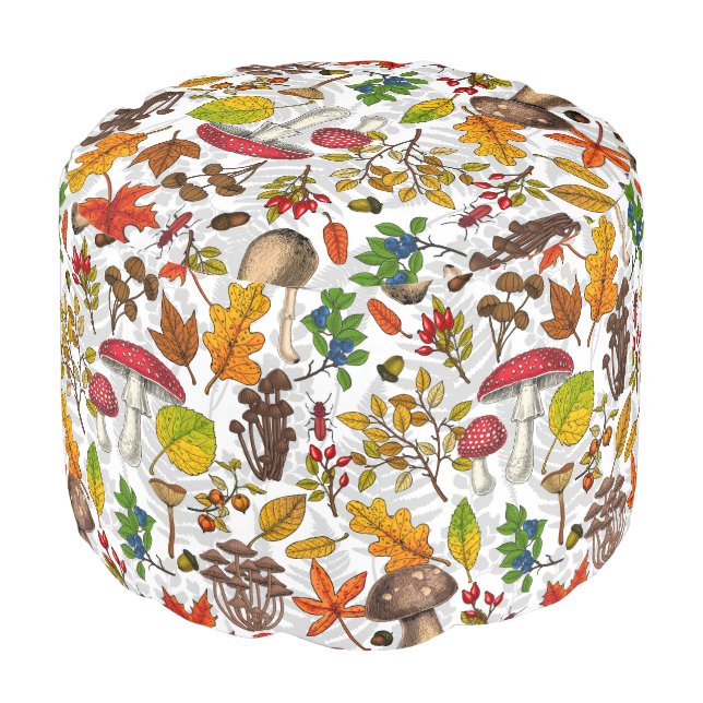 Autumn mushrooms, leaves, nuts and berries on whit pouf (Angled Front)