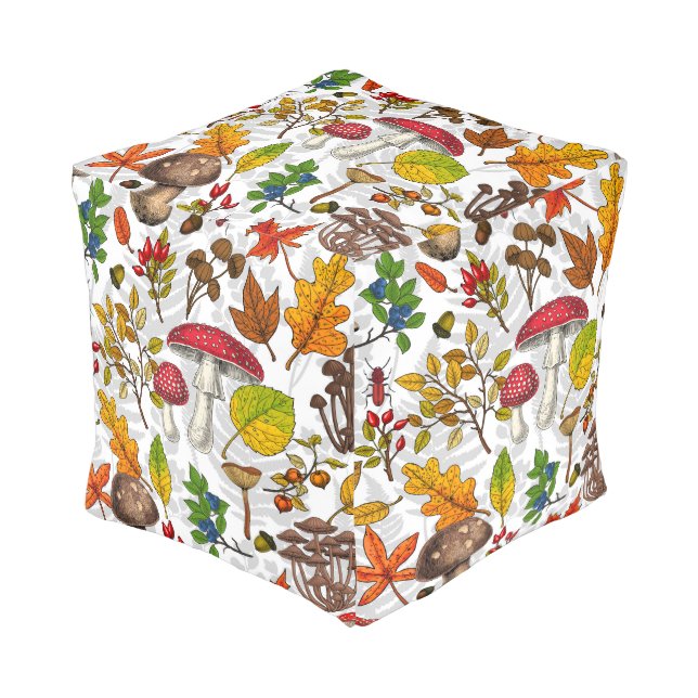 Autumn mushrooms, leaves, nuts and berries on whit pouf (Angled Front)