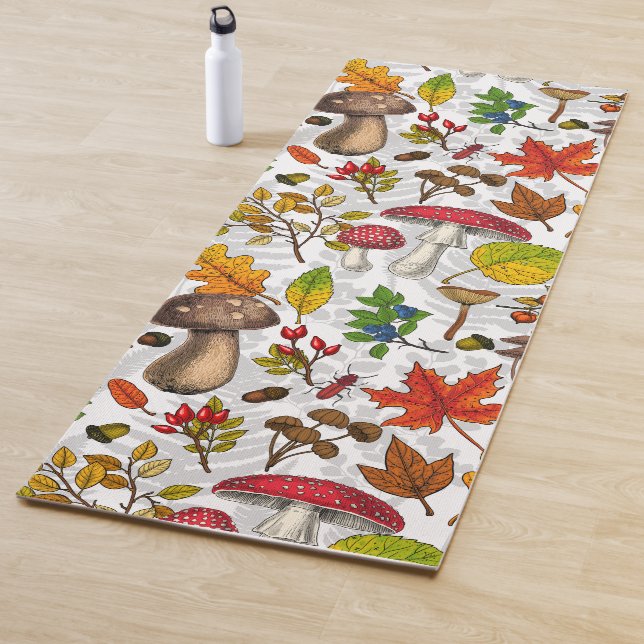 Autumn mushrooms, leaves, nuts and berries on whit yoga mat (In Situ)