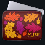 Autumn Oak Leaves and Acorns Monogrammed Laptop Sleeve<br><div class="desc">Autumn is in the air! Simple illustrations of oak leaves and acorns in fall colors of golden yellow,  vibrant orange,  magenta and purple against a brown background surround your initials on this custom monogrammed laptop computer sleeve.</div>