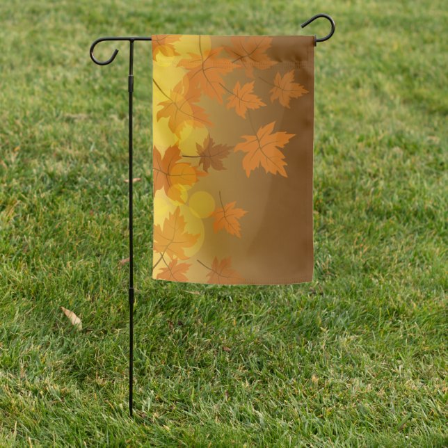 Autumn pattern with falling maple leaves and bokeh garden flag (In SItu)