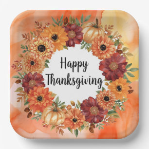 Autumn themed thanksgiving with flowers pumpkins paper plates