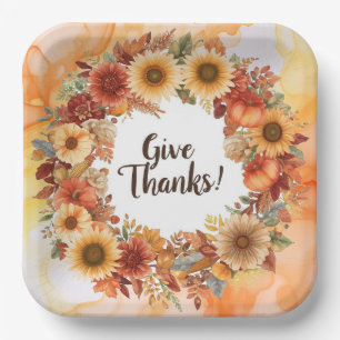 Autumn themed thanksgiving with flowers pumpkins paper plates