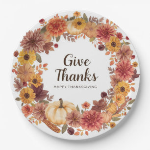 Autumn themed thanksgiving with flowers pumpkins paper plates
