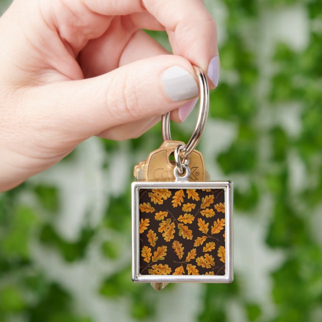 Autumnal oak leaves on dark brown keychain (Hand)