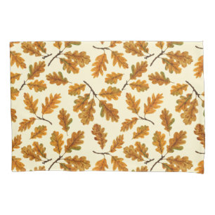 Autumnal oak leaves on off white pillow case
