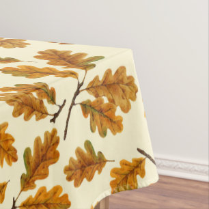 Autumnal oak leaves on off white tablecloth