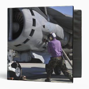 Aviation fuel technician attaches a fuel line binder