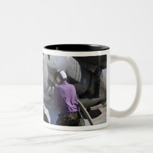 Aviation fuel technician attaches a fuel line Two-Tone coffee mug