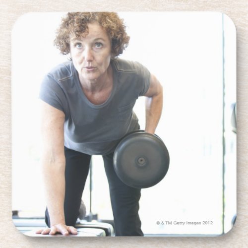 Baby boomer woman working out triceps in health drink coaster