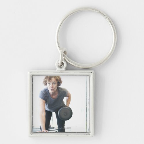 Baby boomer woman working out triceps in health keychain