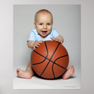 Baby boy (6-9 months) holding basketball, poster