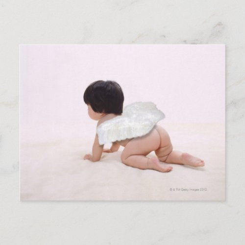 Baby girl in angel wings smiling rear view postcard