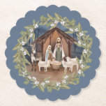 Baby Jesus in the Manger Nativity  Paper Coaster<br><div class="desc">This traditional Christmas coaster features a nativity image of baby Jesus sleeping in a manger with Mary and Joseph in the center. The nativity is surrounded by a wreath with berries on a blue background.</div>
