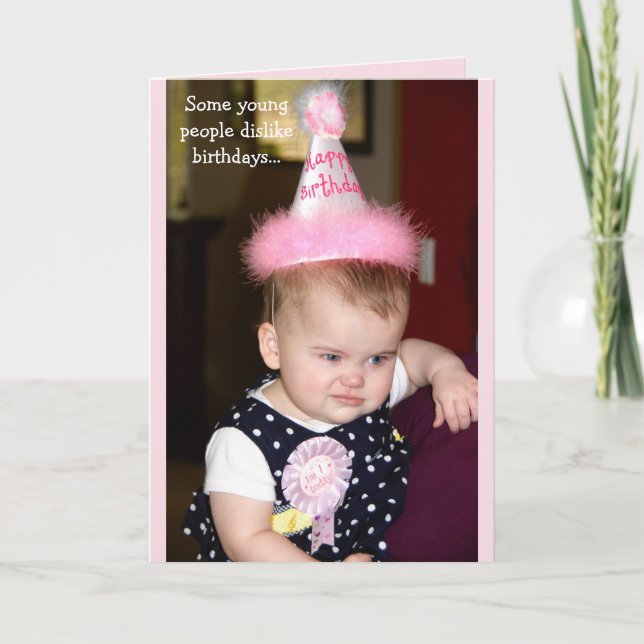 Baby looking grumpy at her first birthday party card (Front)