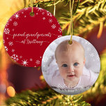 Baby Photo First Christmas Snowflakes Grandparents Ceramic Ornament<br><div class="desc">“First Christmas.” A playful visual of white snowflakes and handwritten script typography with customized year, overlaying the photo of your choice, help you usher in Christmas and New Year. On the back, additional white snowflakes and handwritten typography with “proud grandparents of baby’s name” overlay a red background. Feel the warmth...</div>